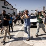 Migrantes celebran luego de expulsar a agentes que intentaban efectuar una redada en el sur de Los Ángeles. Foto Afp